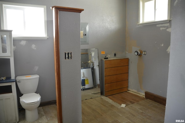 bathroom featuring electric panel and toilet