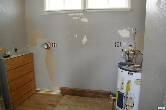 bathroom featuring hardwood / wood-style floors, plenty of natural light, and water heater