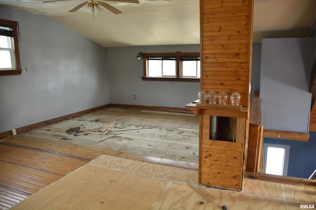 unfurnished living room featuring ceiling fan and lofted ceiling