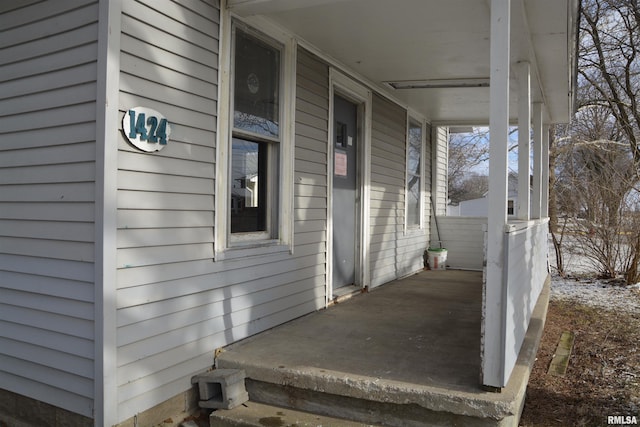 view of side of property with covered porch