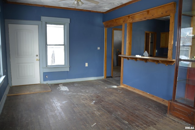 interior space with dark hardwood / wood-style flooring, ceiling fan, and crown molding