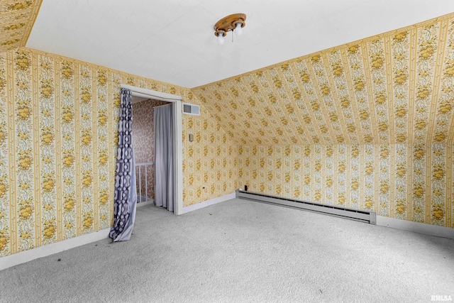 carpeted spare room featuring baseboard heating