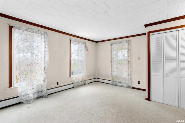 unfurnished bedroom featuring light colored carpet, crown molding, and a closet