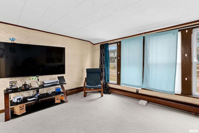 living area with carpet, plenty of natural light, and ornamental molding