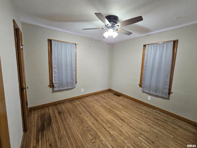 unfurnished room featuring ceiling fan and hardwood / wood-style flooring