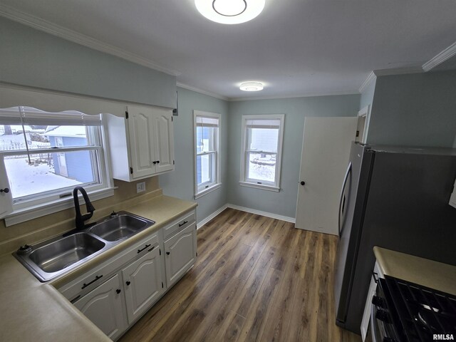 kitchen featuring dark hardwood / wood-style flooring, stainless steel fridge, sink, and white cabinets