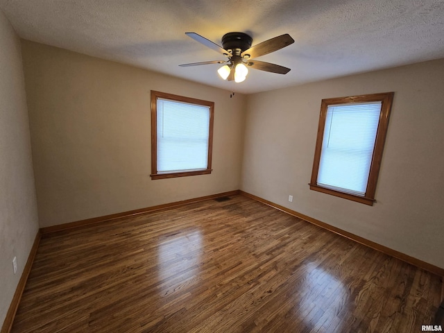 spare room featuring a textured ceiling, dark hardwood / wood-style flooring, and ceiling fan