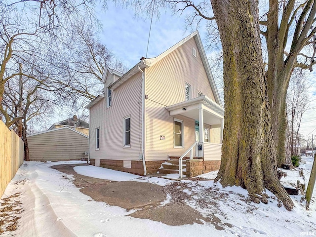 snow covered house with a porch