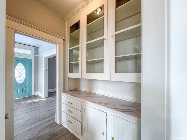 bar featuring white cabinets and hardwood / wood-style floors