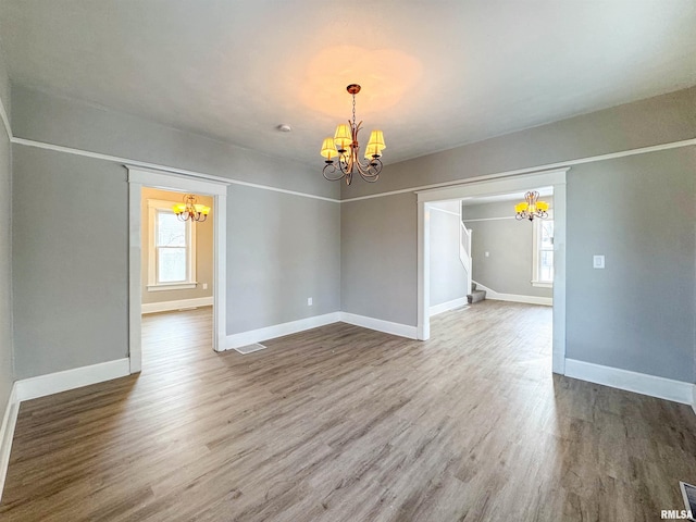 interior space featuring hardwood / wood-style floors and an inviting chandelier