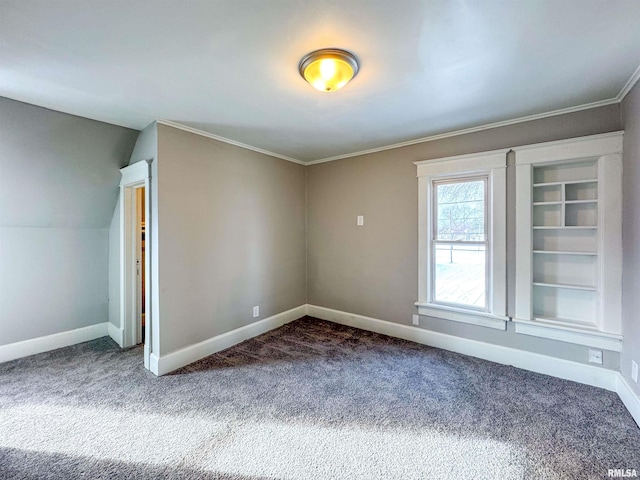 unfurnished room with lofted ceiling, dark carpet, and ornamental molding