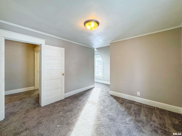 spare room featuring carpet and crown molding