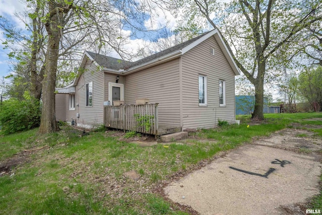 view of side of property with a wooden deck