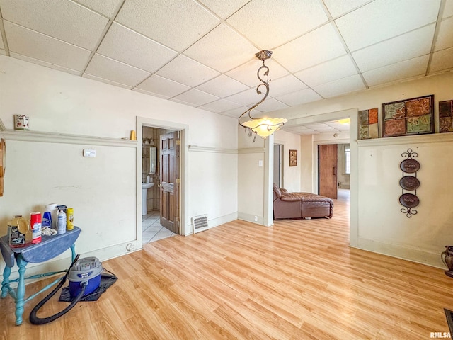 interior space featuring hardwood / wood-style flooring and a drop ceiling