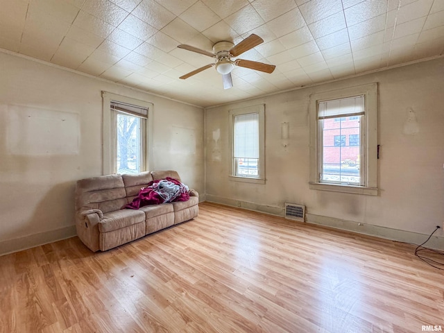 sitting room with ceiling fan, light hardwood / wood-style flooring, and crown molding