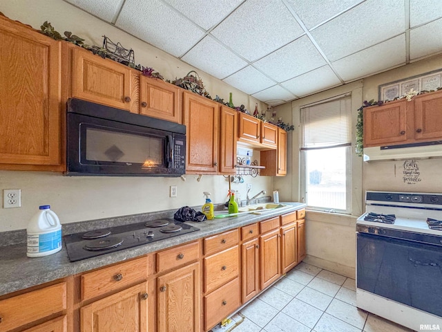 kitchen with sink, a drop ceiling, white range, electric cooktop, and light tile patterned floors