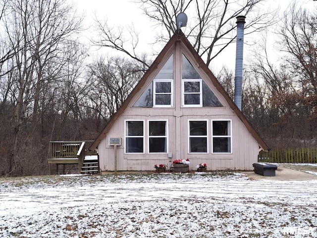 snow covered property featuring a wall mounted air conditioner and a deck