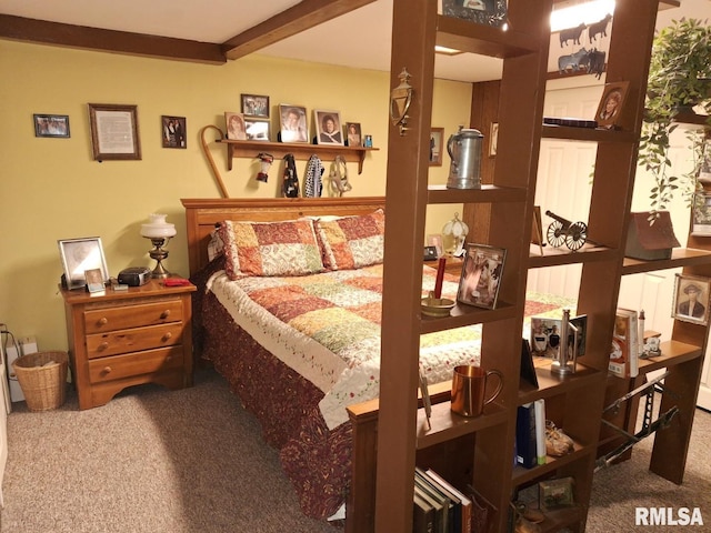 carpeted bedroom with beamed ceiling