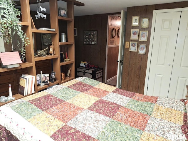 bedroom with wooden walls and a closet