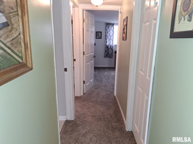 hallway with dark colored carpet