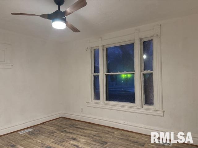 unfurnished room with ceiling fan and dark hardwood / wood-style flooring