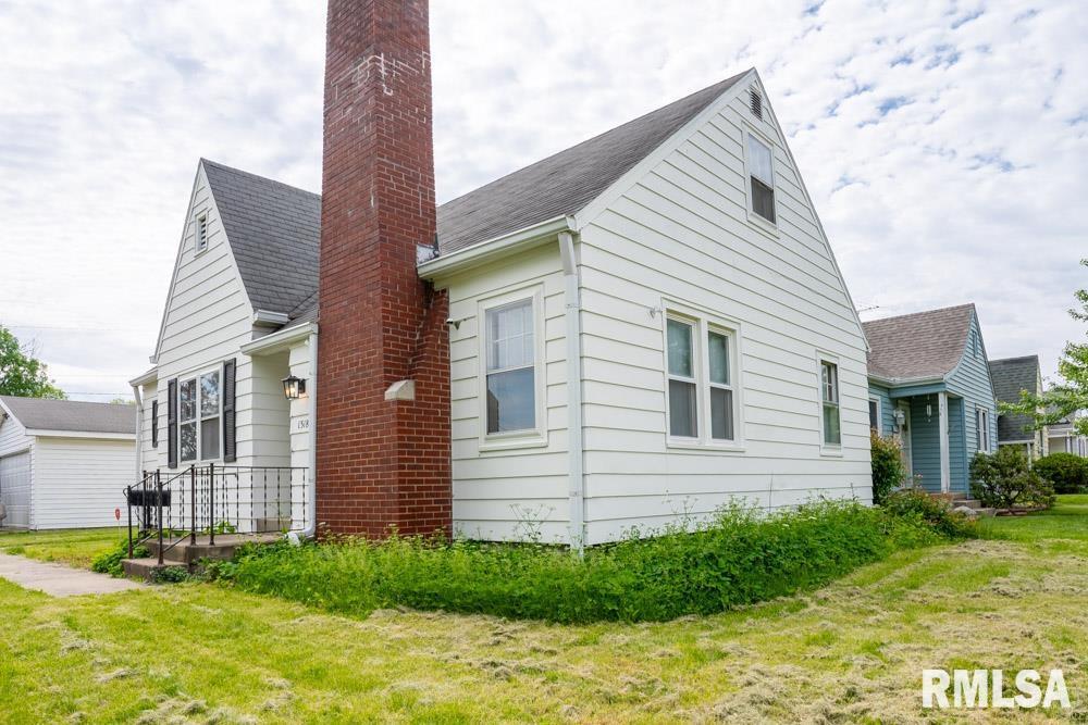 view of side of home featuring a yard