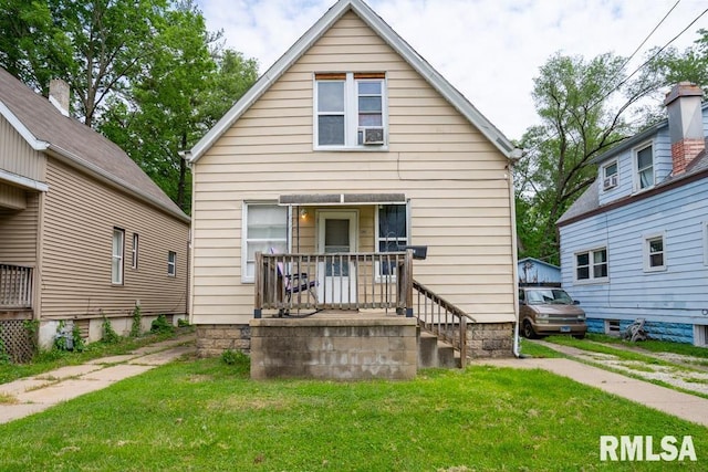 rear view of property with a lawn