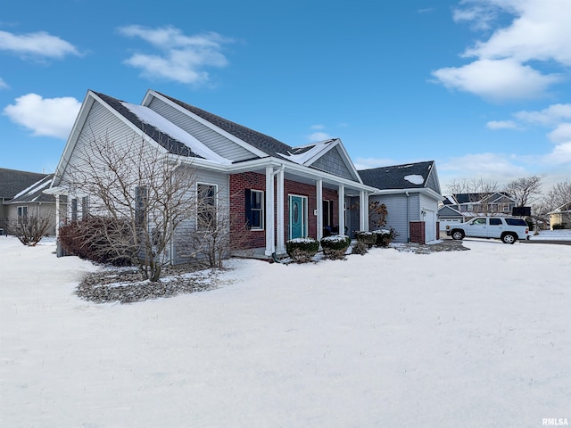 snow covered property with a garage