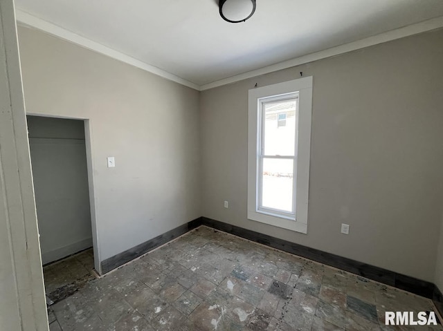 unfurnished bedroom featuring a closet and crown molding