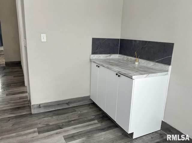 kitchen with dark hardwood / wood-style floors and white cabinetry