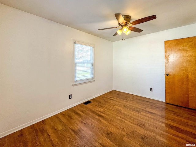 spare room with ceiling fan and dark hardwood / wood-style floors