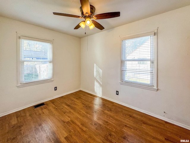 spare room with hardwood / wood-style flooring and ceiling fan