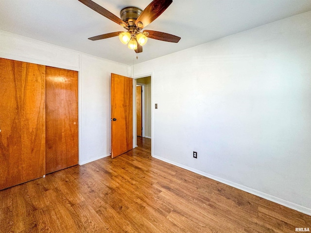 unfurnished bedroom with a closet, light hardwood / wood-style floors, and ceiling fan