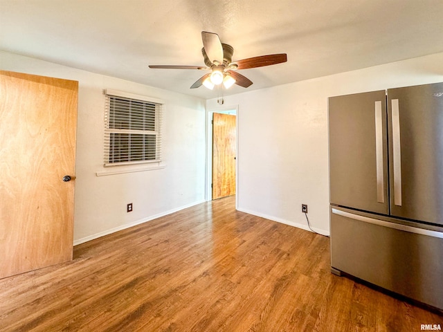 empty room with hardwood / wood-style flooring and ceiling fan