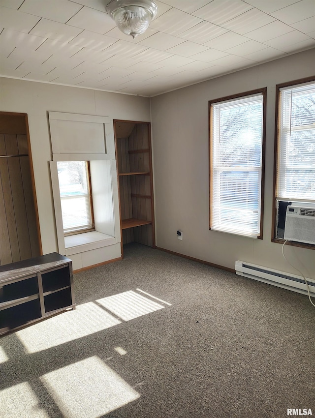 unfurnished living room featuring carpet floors, cooling unit, and a baseboard heating unit