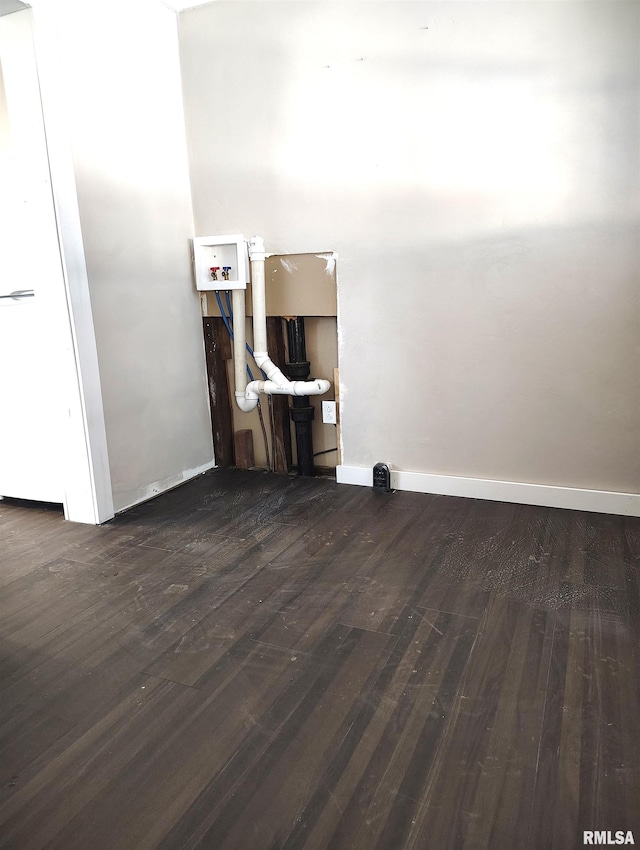 unfurnished room with dark wood-type flooring