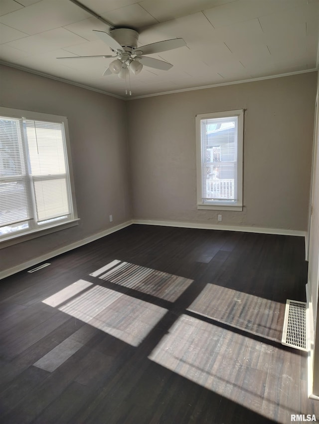 empty room featuring crown molding, ceiling fan, and a healthy amount of sunlight