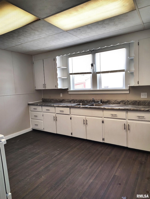 kitchen featuring white cabinetry, sink, dark hardwood / wood-style floors, and range