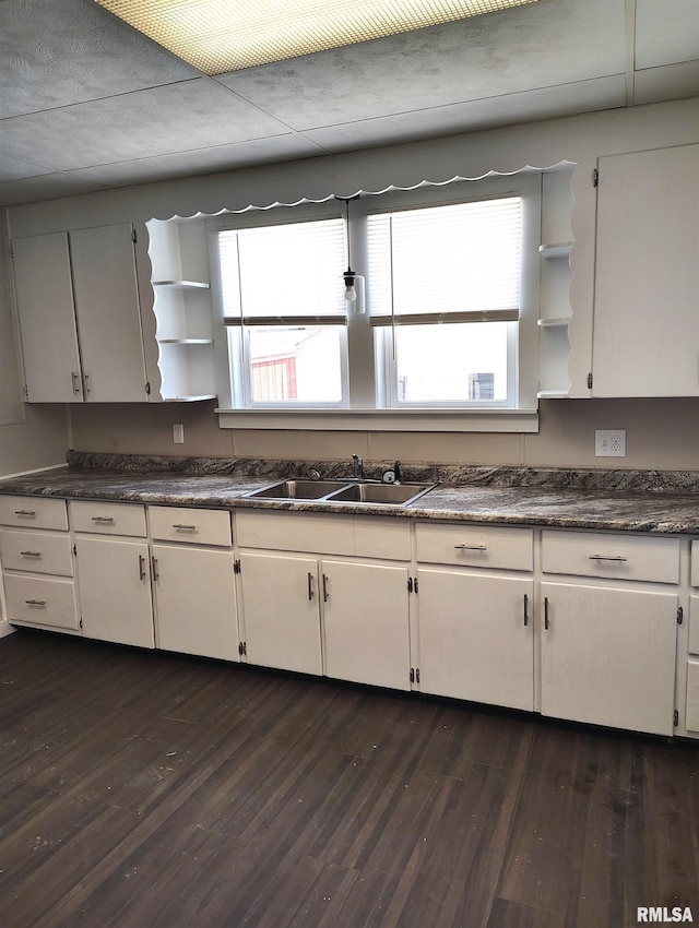 kitchen featuring white cabinets, a wealth of natural light, and sink