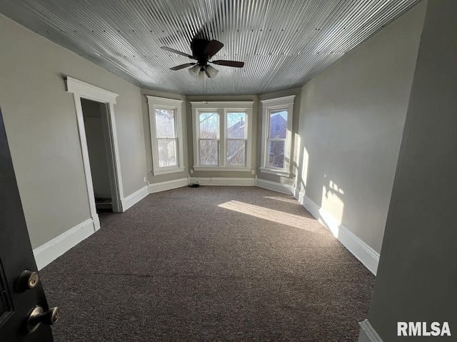 carpeted empty room featuring ceiling fan and wooden ceiling