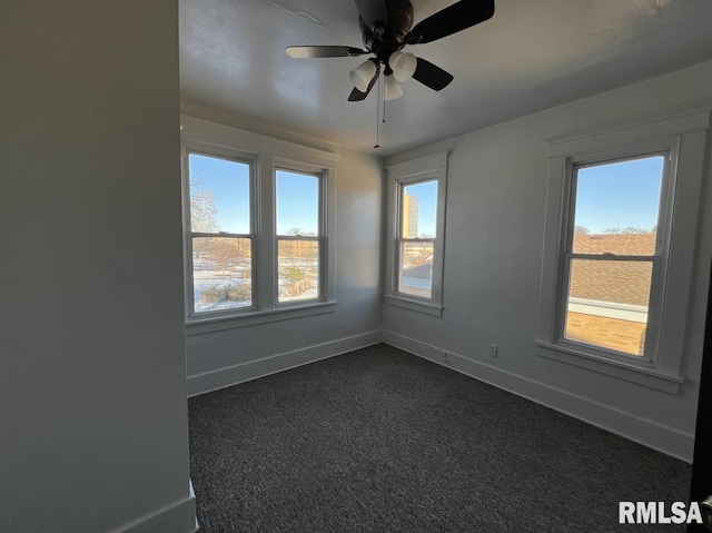 carpeted empty room featuring ceiling fan and plenty of natural light