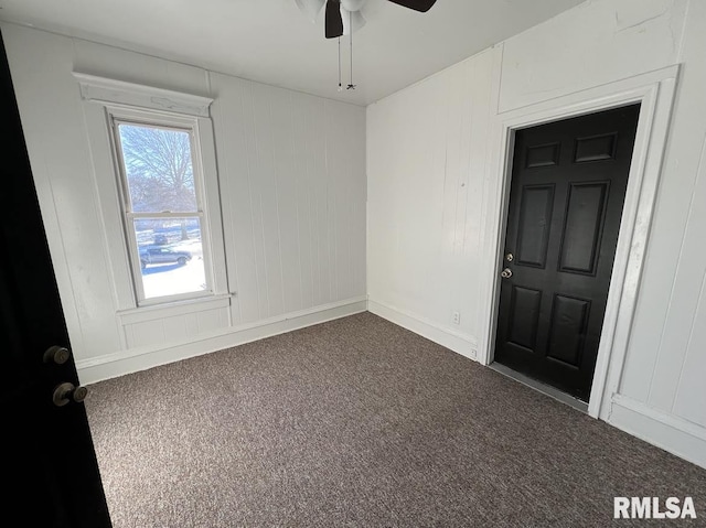 carpeted empty room featuring ceiling fan