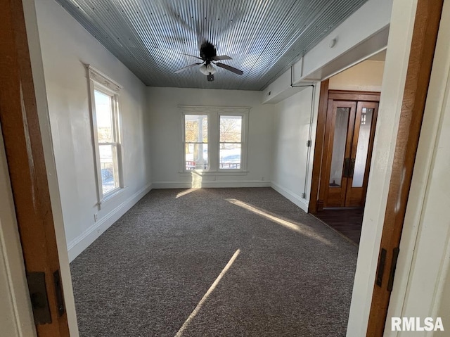 carpeted empty room featuring ceiling fan