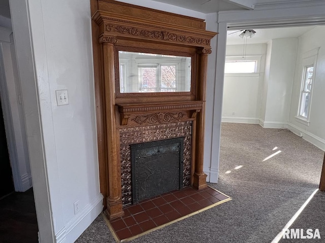 room details with carpet floors and a tiled fireplace