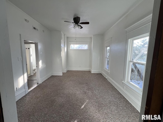 carpeted spare room featuring ceiling fan and a textured ceiling