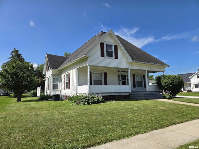 505 W Main St, La Harpe, IL 61450 - view of front facade featuring covered porch, a front lawn, and a shingled roof