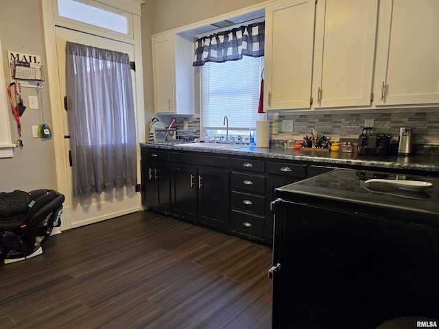 505 W Main St, La Harpe, IL 61450 - kitchen featuring dark cabinets, white cabinets, electric range oven, and healthy amount of natural light