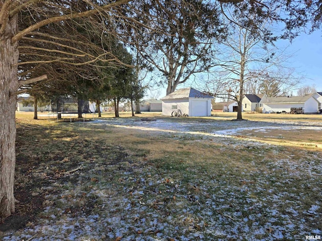 view of yard with an outbuilding, a garage, and a trampoline