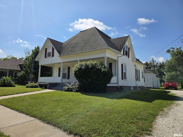 505 W Main St, La Harpe, IL 61450 - view of home's exterior featuring a shingled roof, covered porch, and a lawn