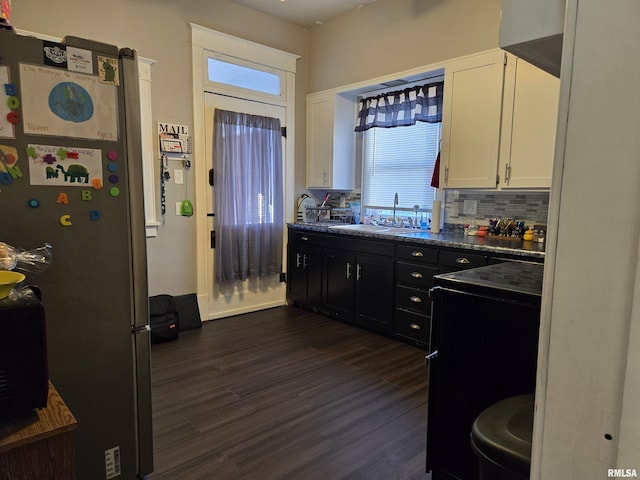 kitchen with stainless steel fridge, white cabinetry, a wealth of natural light, and sink